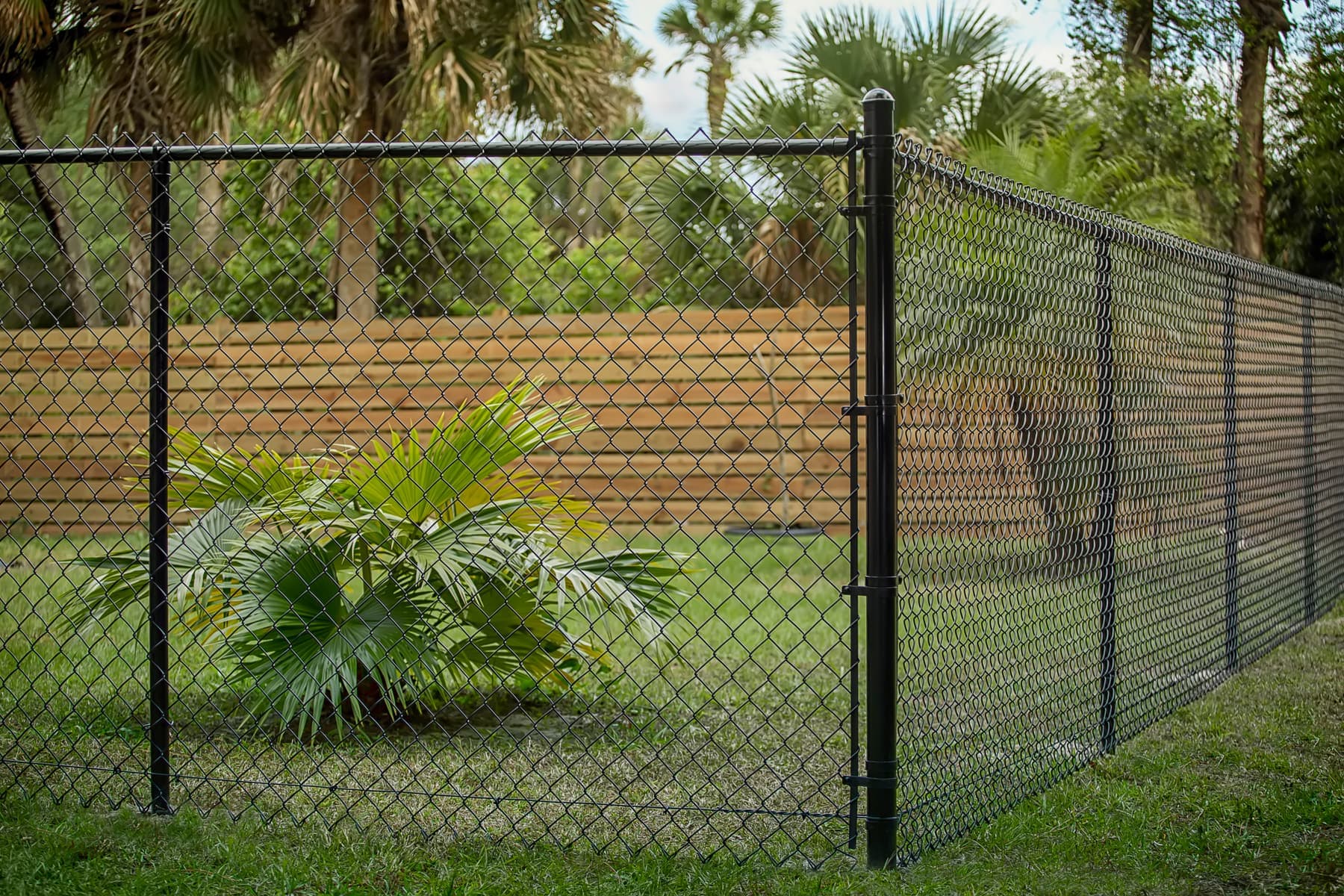 Black chain-link fence with a gate post